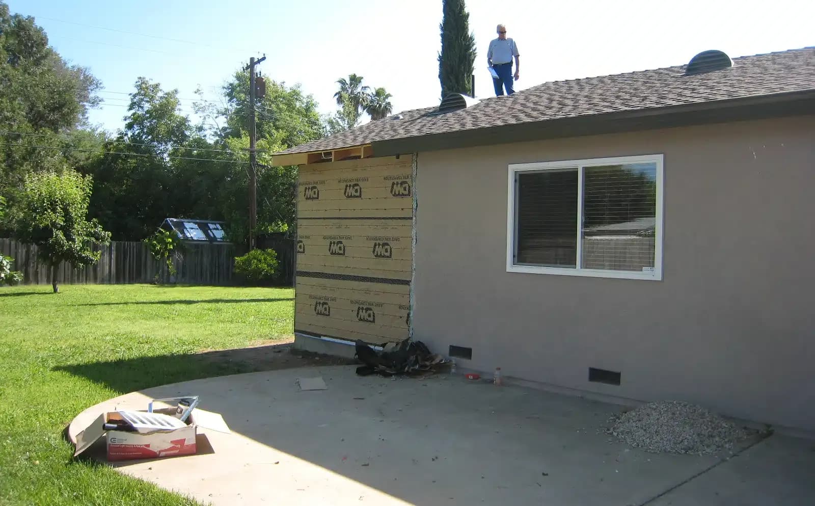 Man standing atop roof